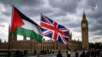 Palestinian and British flags waving in front of the Palace of Westminster in London