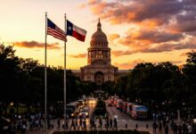 The Texas State Capitol building at sunset with protesters and campaign buses on the street
