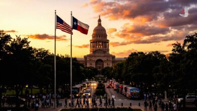 The Texas State Capitol building at sunset with protesters and campaign buses on the street