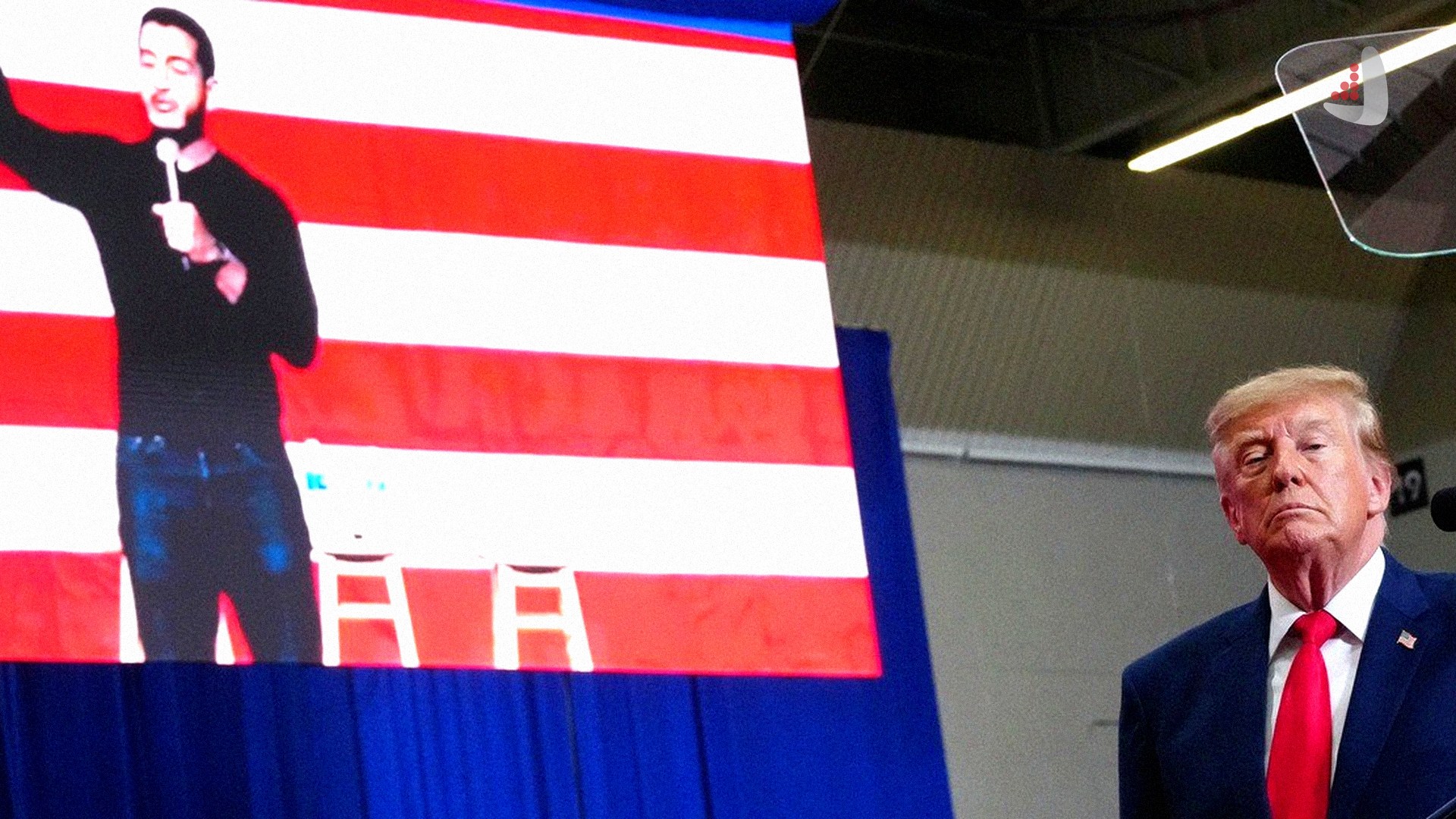 Donald Trump speaks at an election rally in Michigan, with an image of Abdul El-Sayed, the Democratic candidate for the U.S. Senate, displayed on the screen behind him