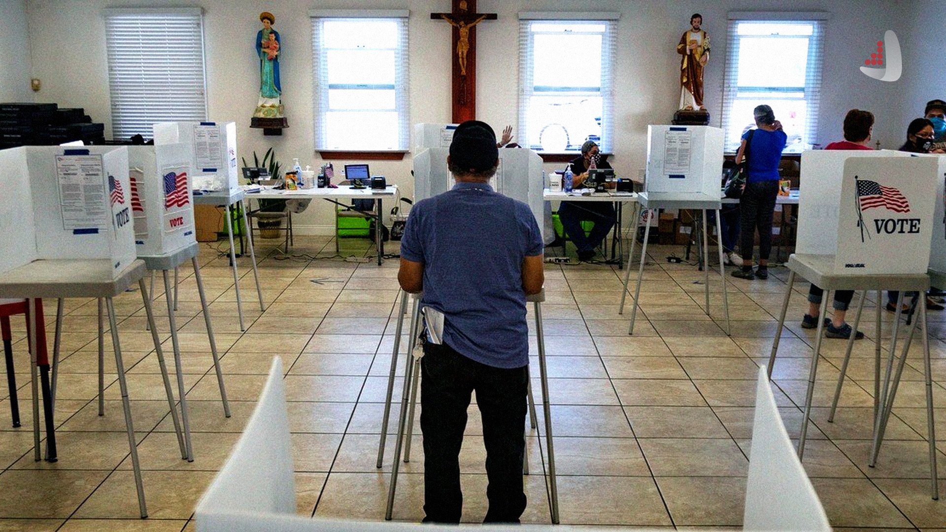 A man fills out a ballot at a polling station, while a statue of Jesus Christ on the cross is visible on the wall in front of him