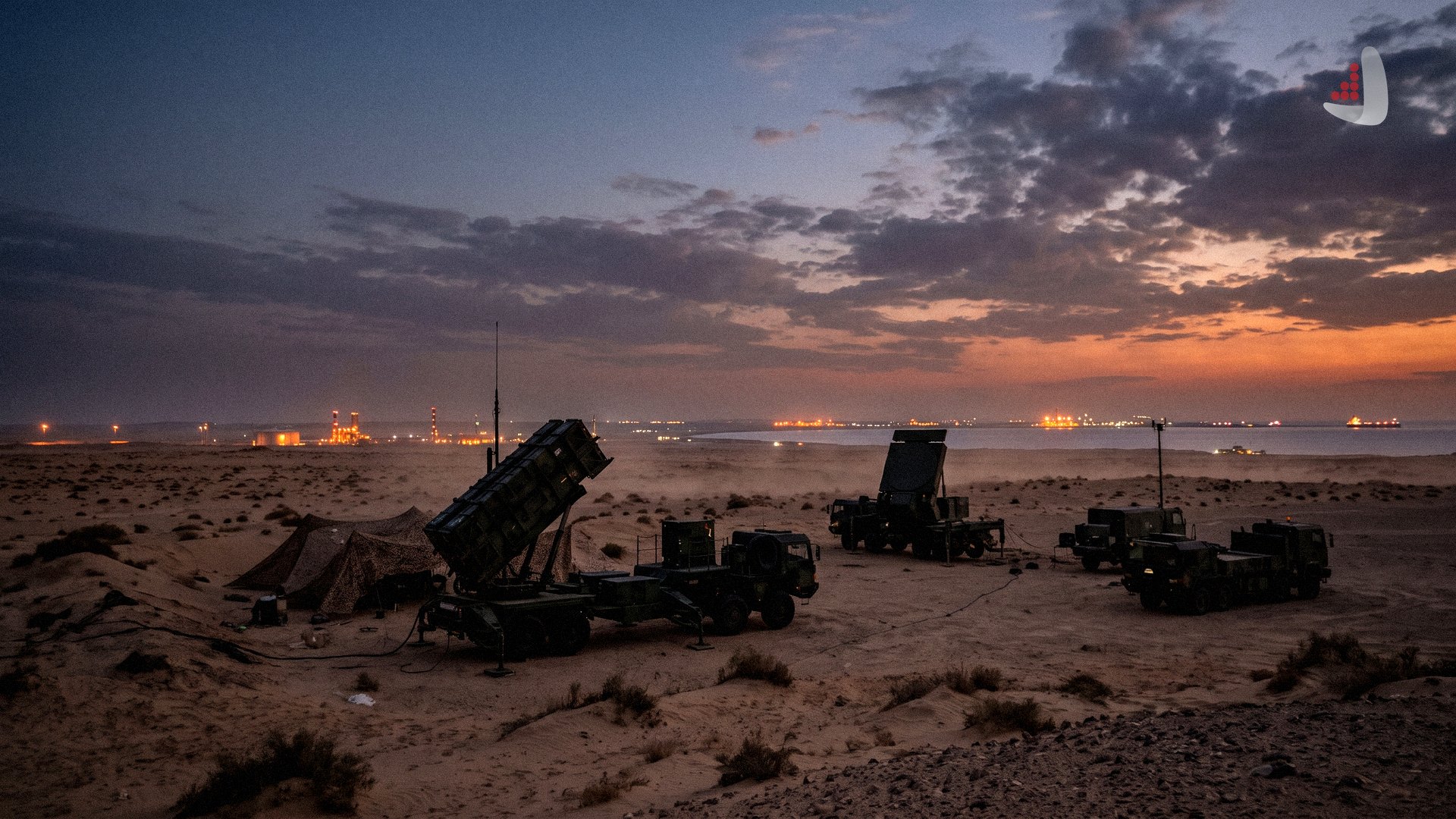 Patriot missile defense systems deployed in a coastal desert area at sunset