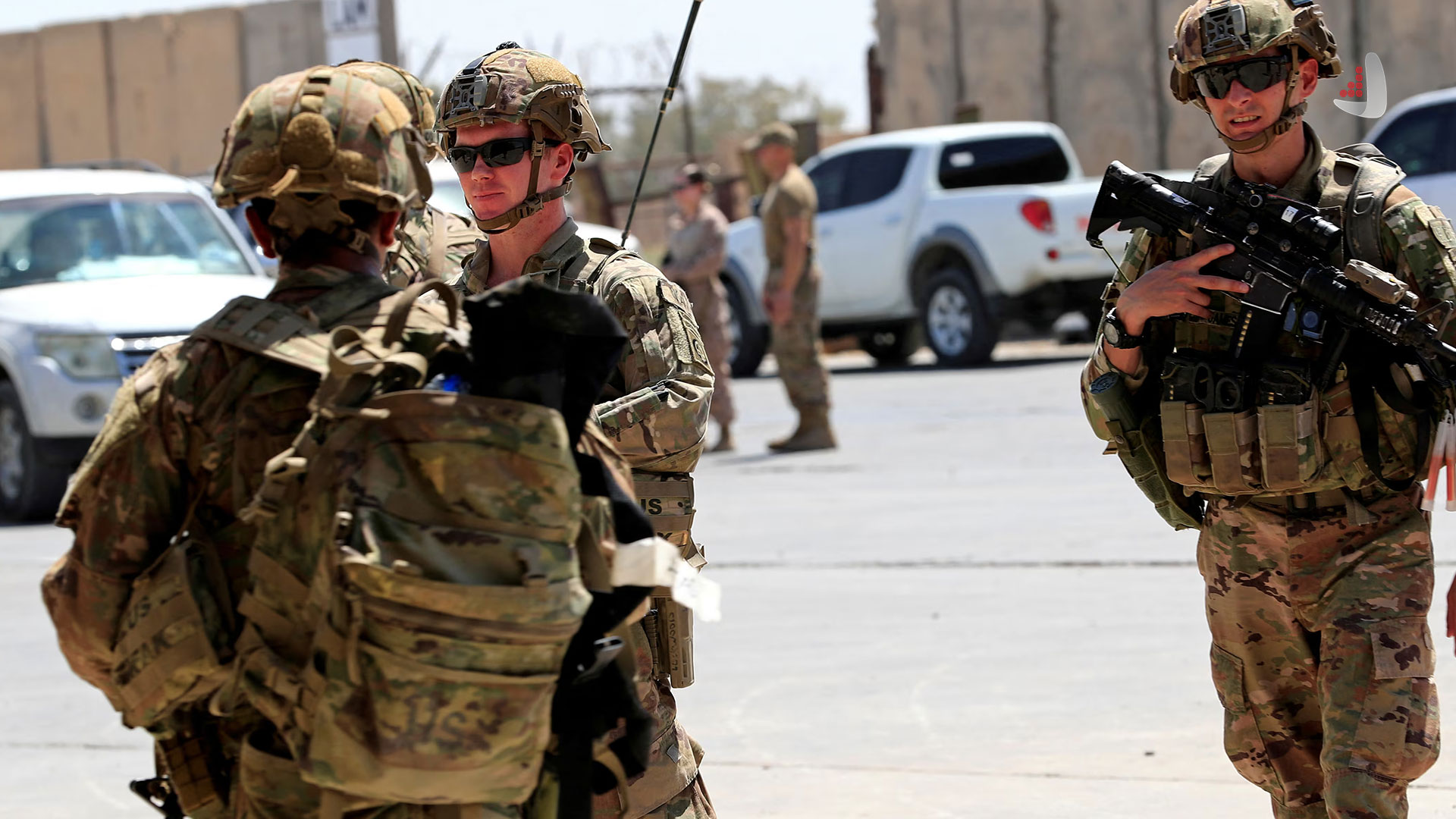 US military personnel conversing at a military base in Iraq