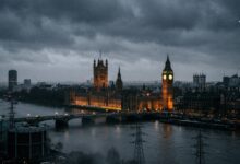 The illuminated Palace of Westminster and Big Ben under a dark, stormy sky in London