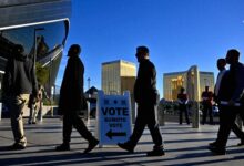 A group of citizens stands in line waiting to vote at a polling station in the United States