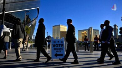A group of citizens stands in line waiting to vote at a polling station in the United States