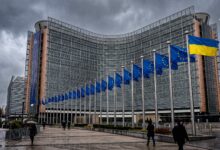 Ukrainian and European Union flags flying in front of the Berlaymont building in Brussels