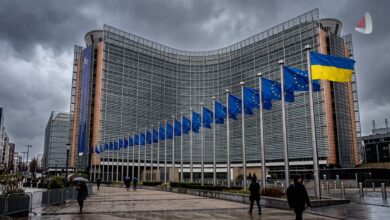 Ukrainian and European Union flags flying in front of the Berlaymont building in Brussels
