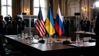 Flags of the United States, Ukraine, and Russia on a wooden conference table