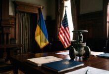 Industrial valve on a desk next to folders and the flags of the US and Ukraine