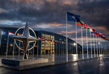 NATO star sculpture and member state flags outside the NATO headquarters in Brussels